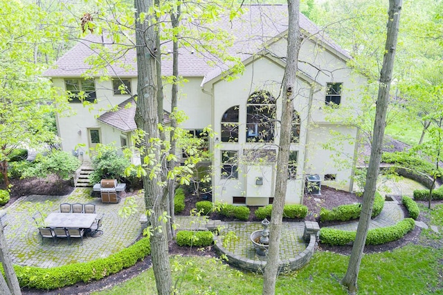 8884 Filiz Ln, Powell, OH 43065 - rear view of property with stucco siding and a patio area