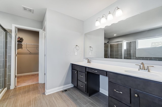 3781 Aviary Loop, Hilliard, OH 43026 - bathroom with double vanity, visible vents, a stall shower, and a sink
