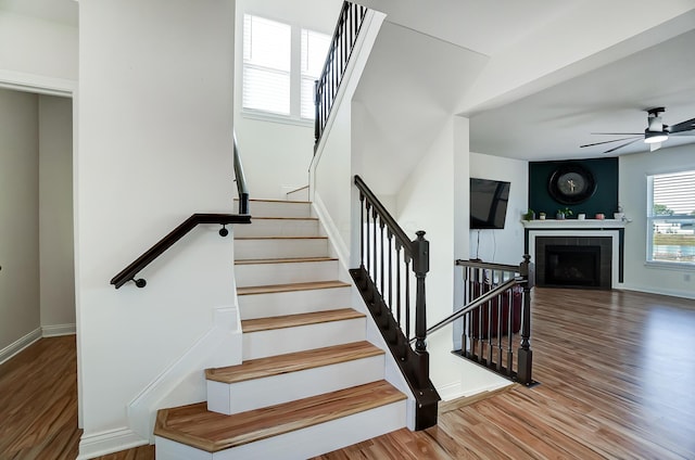 3781 Aviary Loop, Hilliard, OH 43026 - stairway with a ceiling fan, baseboards, a tiled fireplace, and wood finished floors