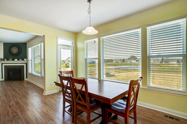 3781 Aviary Loop, Hilliard, OH 43026 - dining room with baseboards, a fireplace, visible vents, and wood finished floors
