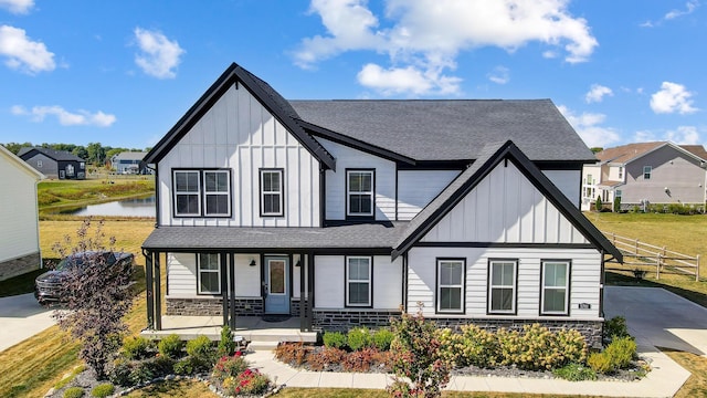 3781 Aviary Loop, Hilliard, OH 43026 - modern farmhouse with stone siding, board and batten siding, a porch, and roof with shingles