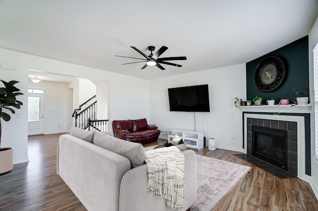 3781 Aviary Loop, Hilliard, OH 43026 - living room with wood finished floors, stairway, a ceiling fan, baseboards, and a tiled fireplace