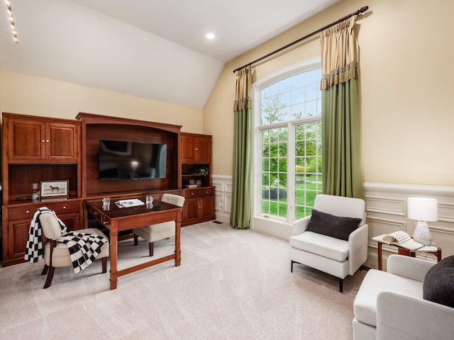 living area with vaulted ceiling, light carpet, wainscoting, a decorative wall, and recessed lighting