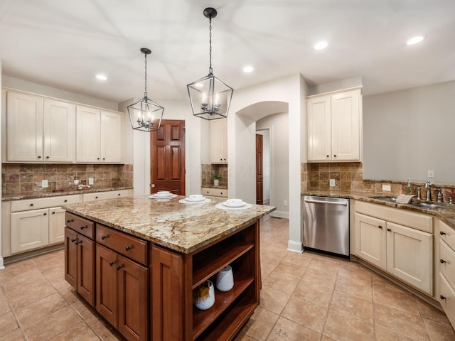 kitchen with stainless steel dishwasher, arched walkways, a sink, tasteful backsplash, and light stone countertops