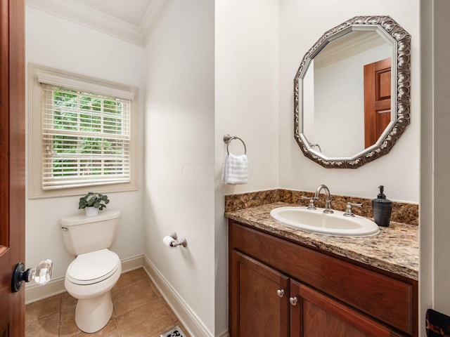 bathroom featuring crown molding, toilet, baseboards, tile patterned flooring, and vanity