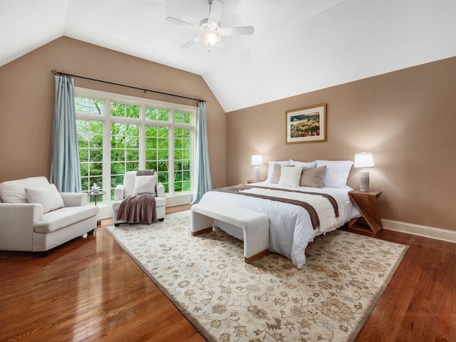 bedroom featuring lofted ceiling, wood finished floors, a ceiling fan, and baseboards