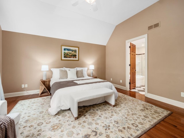 bedroom with lofted ceiling, wood finished floors, and baseboards