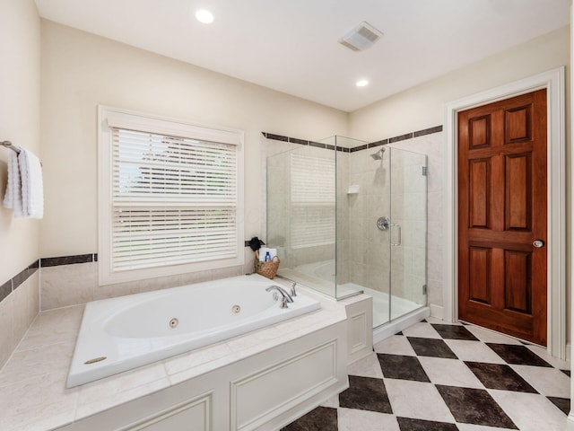 bathroom with a stall shower, a jetted tub, and recessed lighting