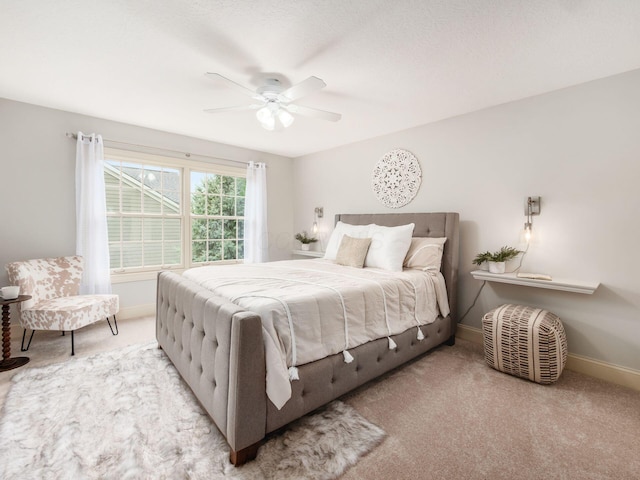 carpeted bedroom featuring baseboards and ceiling fan