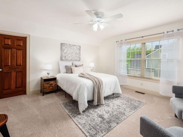 carpeted bedroom with baseboards, ceiling fan, and lofted ceiling