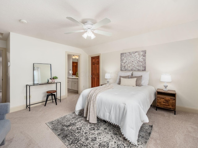 bedroom with light carpet, baseboards, ensuite bath, and a ceiling fan