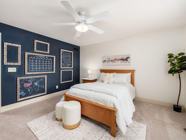 carpeted bedroom featuring baseboards and ceiling fan