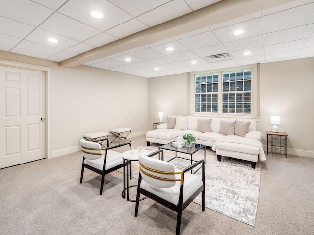 living area featuring carpet, baseboards, recessed lighting, and a paneled ceiling