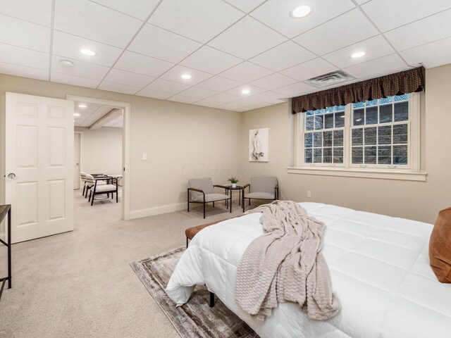 carpeted bedroom featuring recessed lighting and a drop ceiling