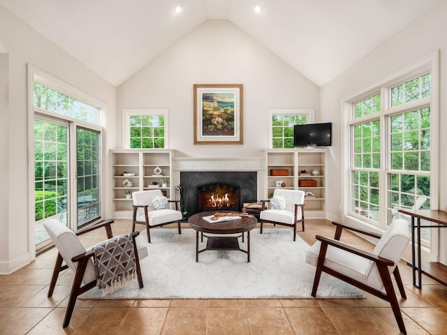 living area with lofted ceiling and a warm lit fireplace