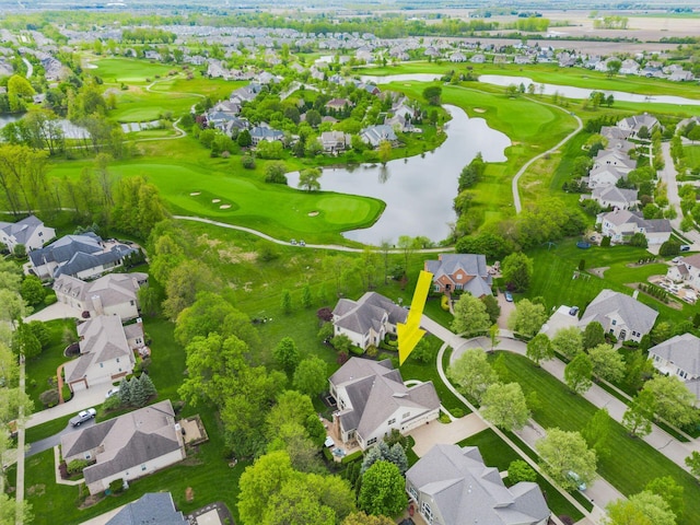 aerial perspective of suburban area with a nearby body of water and a golf club