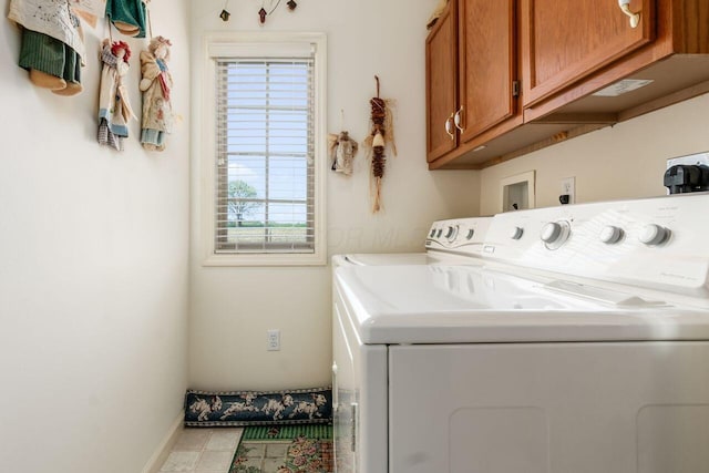 washroom with baseboards, a wealth of natural light, cabinet space, and washer and clothes dryer