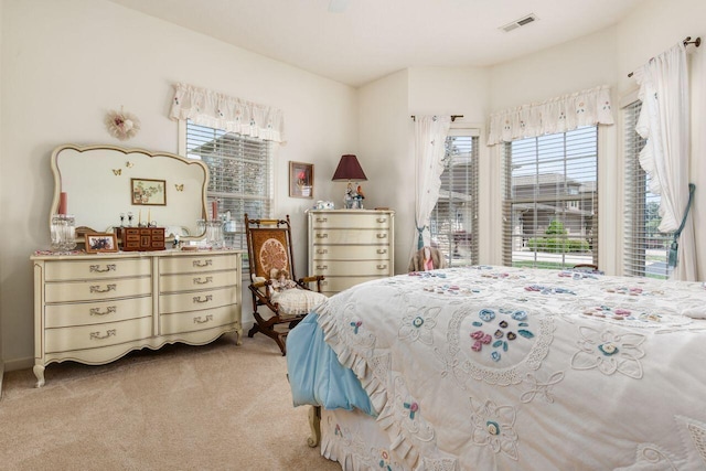 bedroom with visible vents and light carpet