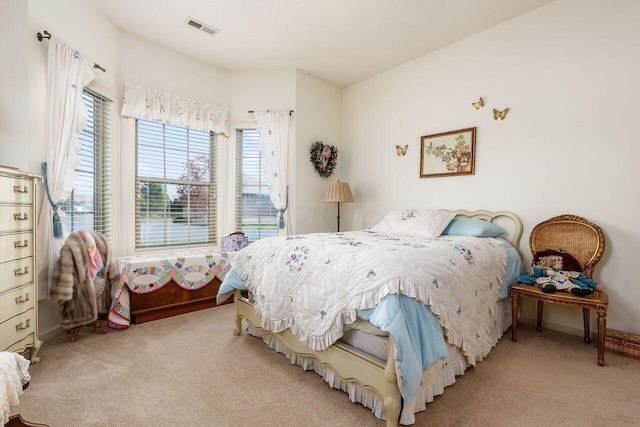 carpeted bedroom with baseboards and visible vents