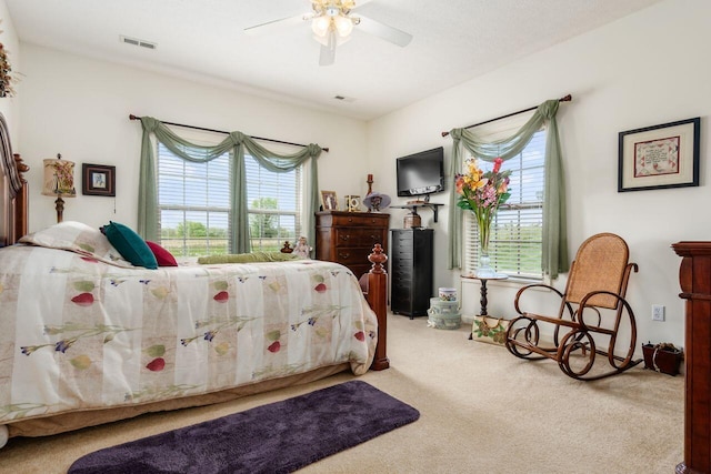 bedroom with a ceiling fan, visible vents, and carpet