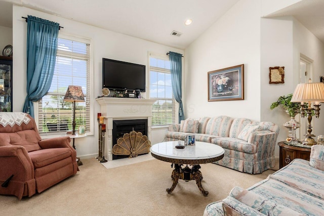 carpeted living room featuring visible vents, a fireplace with flush hearth, a wealth of natural light, and vaulted ceiling
