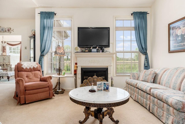 living room featuring a glass covered fireplace and carpet