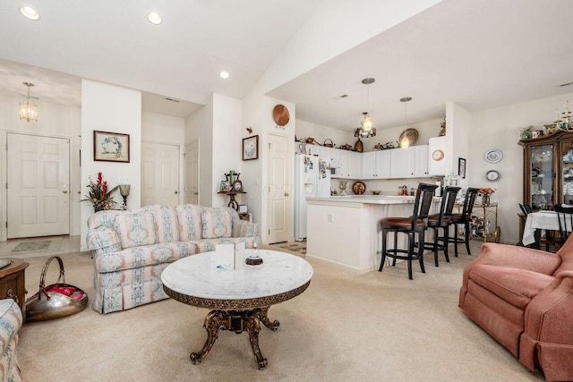 living area featuring an inviting chandelier, vaulted ceiling, recessed lighting, and light colored carpet