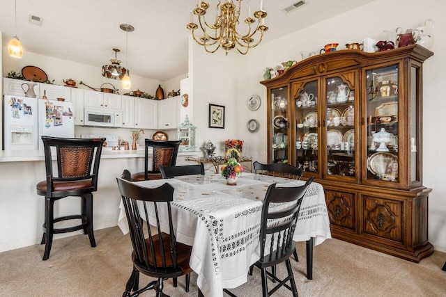 dining space with an inviting chandelier, light carpet, and visible vents