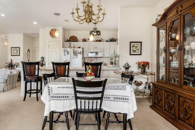 dining area featuring recessed lighting, a notable chandelier, and light carpet