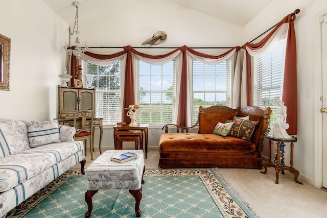 sitting room featuring carpet floors, baseboards, vaulted ceiling, and a wealth of natural light