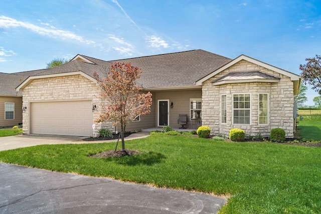 ranch-style house featuring roof with shingles, a front lawn, stone siding, a garage, and concrete driveway