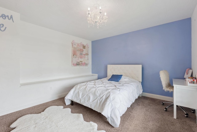 carpeted bedroom featuring baseboards and a chandelier
