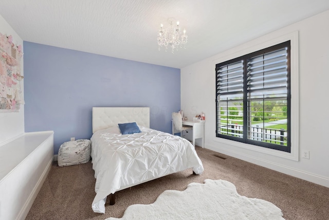 bedroom with baseboards, a notable chandelier, visible vents, and carpet