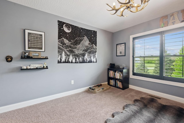 miscellaneous room featuring carpet, visible vents, baseboards, and a notable chandelier