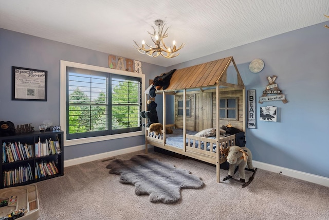bedroom with carpet flooring, a chandelier, and baseboards