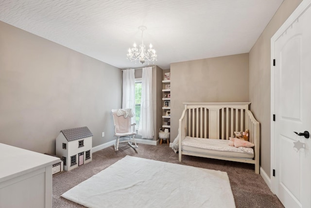 carpeted bedroom with baseboards and a notable chandelier