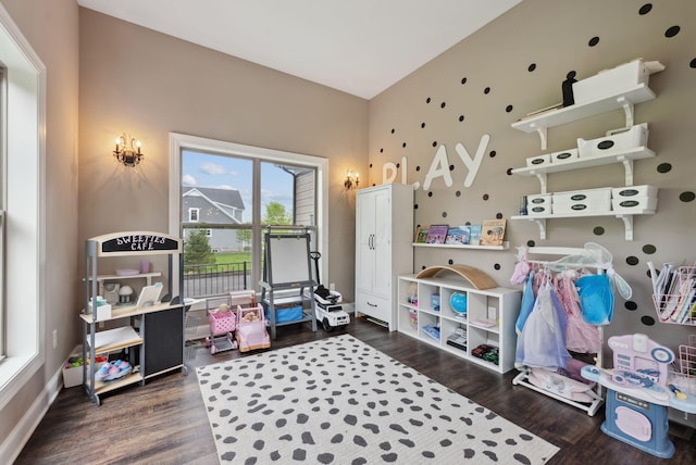 playroom with baseboards and wood finished floors