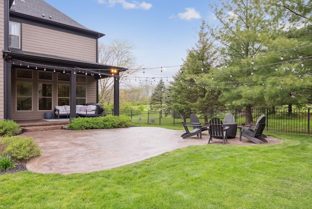 view of yard featuring a patio, outdoor lounge area, and fence