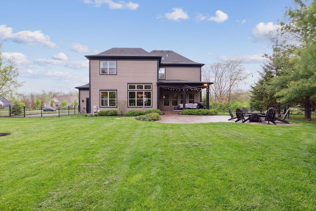 rear view of house with an outdoor fire pit, a yard, a patio, and a fenced backyard