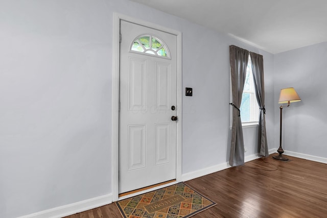 entryway featuring baseboards and wood finished floors