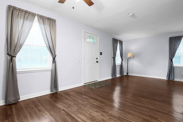 foyer featuring ceiling fan, wood finished floors, and baseboards