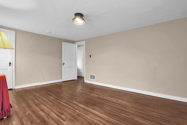 unfurnished room with wood finished floors and baseboards