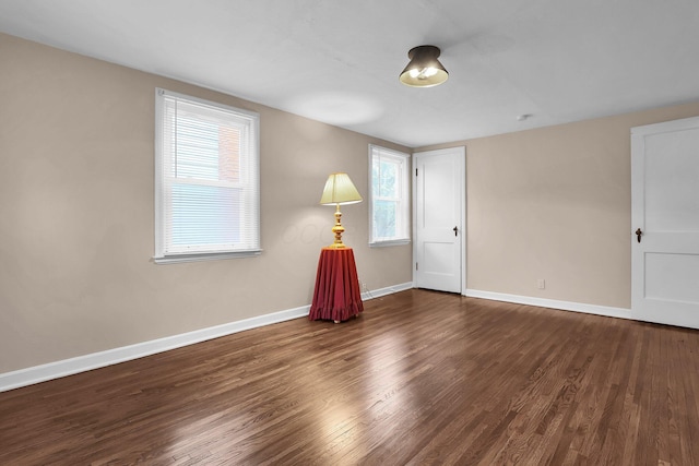 unfurnished room featuring wood finished floors and baseboards