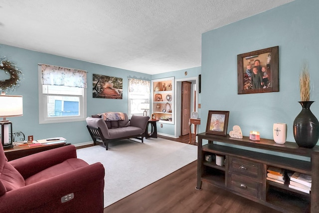 home office with dark wood-type flooring and a textured ceiling