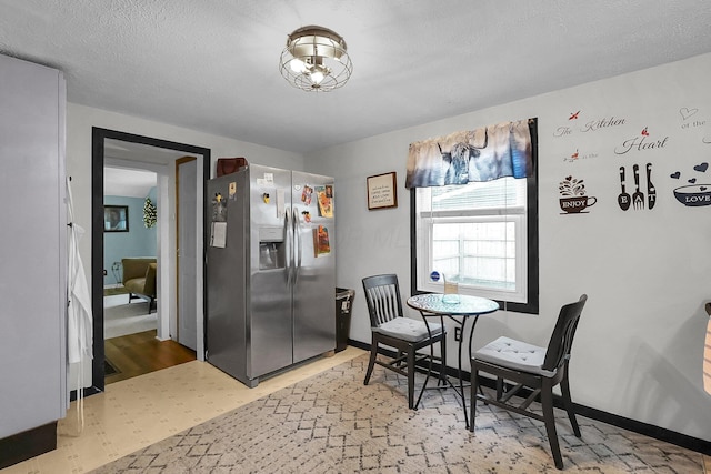 dining space with light wood-style floors and baseboards