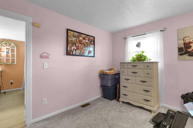 bedroom featuring light carpet and baseboards