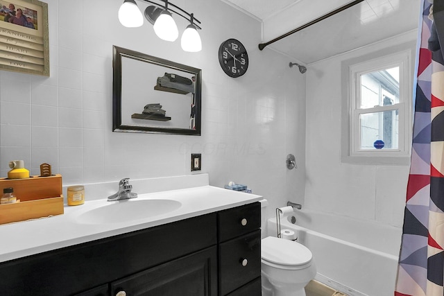 full bathroom featuring toilet, vanity, and shower / bathtub combination with curtain