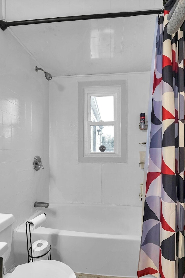 bathroom with toilet and shower / bath combination with curtain