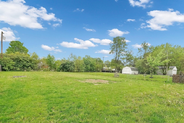 view of yard featuring a storage shed and an outdoor structure