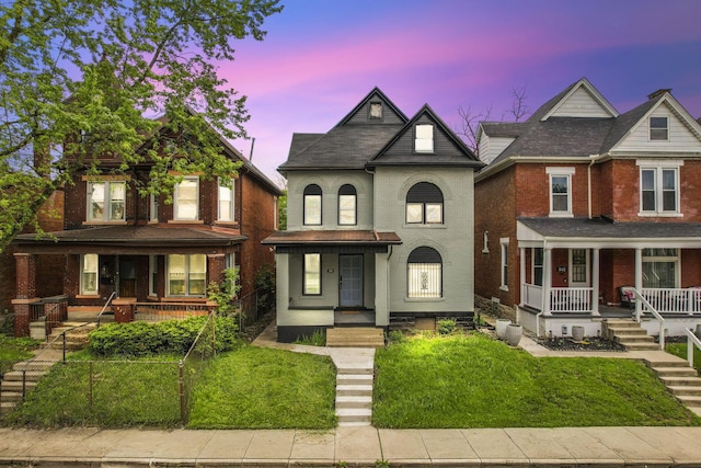 838 Wilson Ave, Columbus, OH 43206 - view of front of home featuring a porch, brick siding, stairs, and a yard